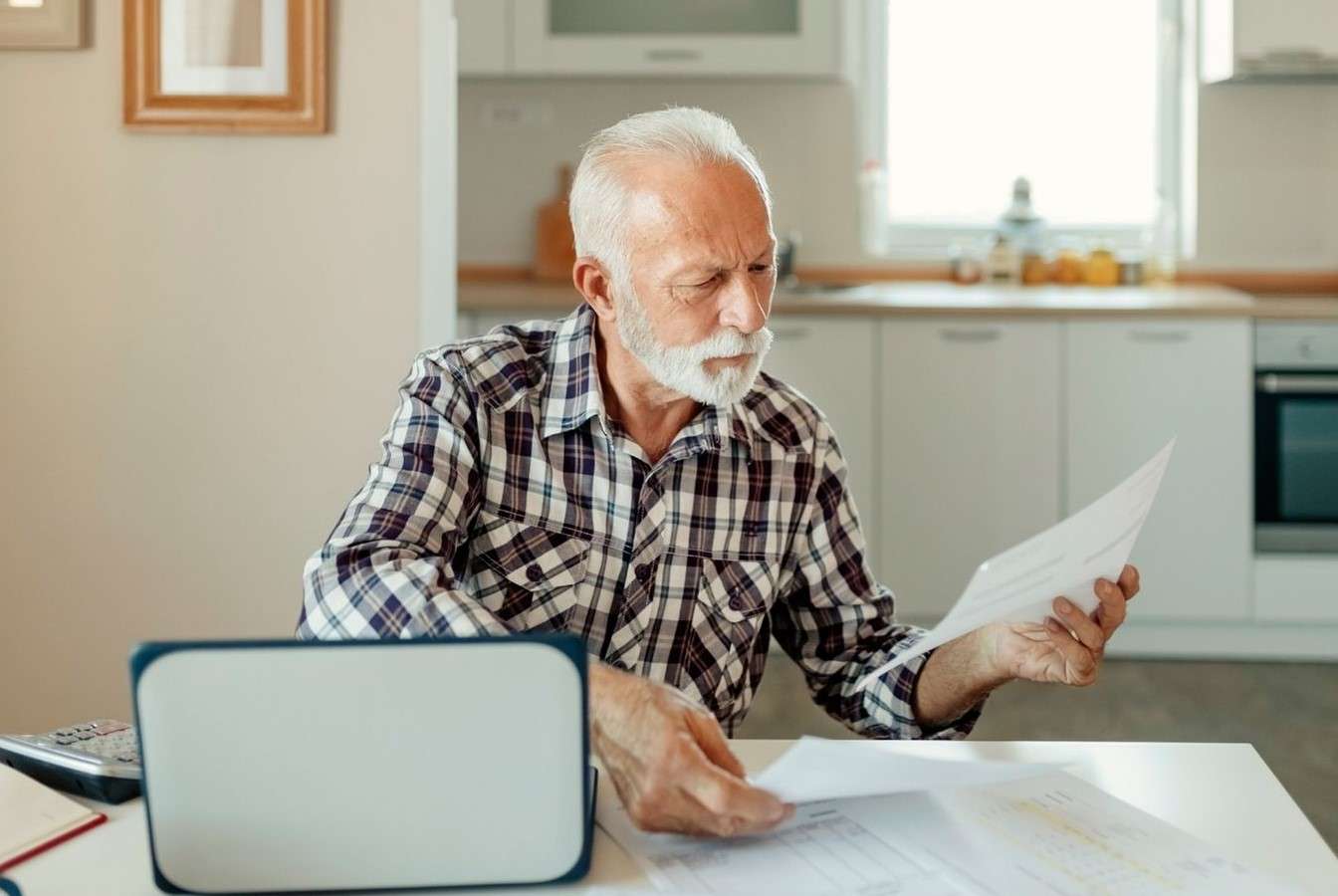 a man reads a piece of paper